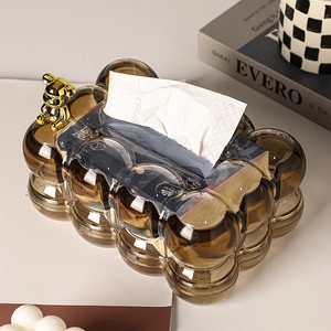 Macro detail of amber wave texture tissue box with golden decorative bear on top