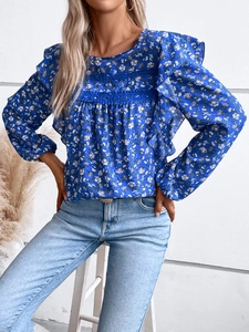 Detail of blue floral print long sleeve blouse with elegant ruffle trim and lace accents