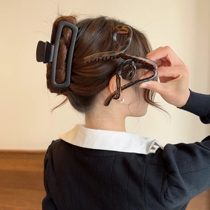 Detailed view of elegant acetate hair claws in black, tortoiseshell, and brown styles