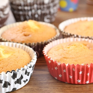 Close-up of assorted patterned cupcake liners on a rustic wood background