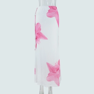 Detailed close-up of white mesh maxi skirt featuring large pink floral prints and flowy fabric