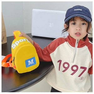Détail d'un sac bandoulière jaune en nylon pour enfant avec texte Sport sur un mannequin