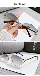 Macro detail of rimless grey brown gradient sunglasses with golden metal claw accents