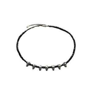 Gothic beaded necklace with black faceted beads and seven silver skull pendants