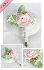 Detail of blush pink artificial wedding boutonniere with green leaves and white beads