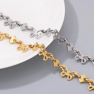 Macro detail of gold and silver butterfly link jewelry chain made of high-grade titanium steel