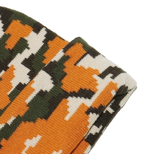Macro detail of high-quality pixelated camouflage knit texture on warm winter beanie hat