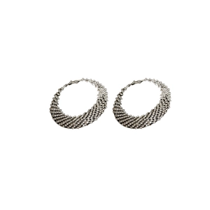 Exaggerated silver circle hoop earrings with luxury woven texture and metal finish