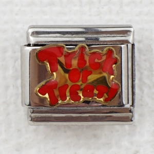 Macro detail of silver charm link with red Trick or Treat enamel for modular bracelet