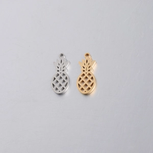 Detailed view of hollow pineapple pendants in gold and silver mirror finish stainless steel