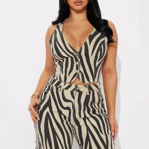Detail of V-neck zebra print vest and high-waist straight trousers set in beige and black