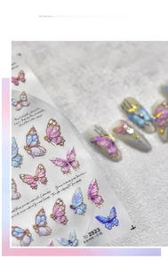 Detail of embossed butterfly nail art stickers with 3D texture and iridescent laser finish