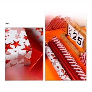 Detail of red Christmas gift wrapping paper rolls with star patterns and glossy textures