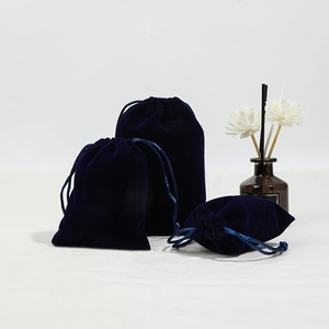Navy blue velvet drawstring jewelry pouches in three sizes with a luxury soft texture