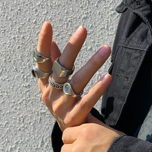 Men's silver geometric ring set featuring textured woven and engraved metal bands