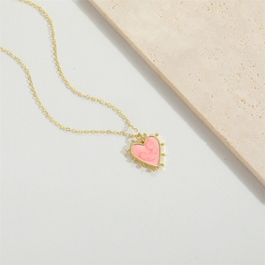 Golden necklace with pink heart pendant featuring embossed mother and child design