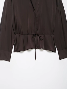 Detail of coffee satin shirt showing luxury silk texture and waist drawstring design