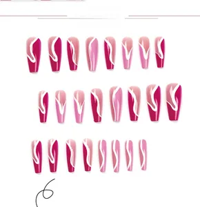 Detailed view of long coffin press-on nails with rose pink gradient and white wave patterns