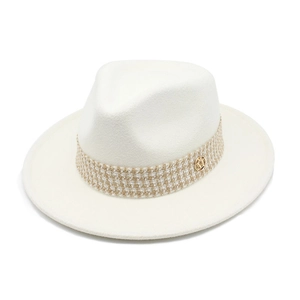 Detail of the tweed band with golden M-logo on a beige felt fedora hat