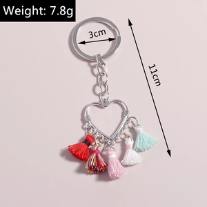 Macro shot of heart fringe keychain showing 11cm length and colorful tassels