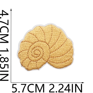 Detailed view of seashell embroidery patch in yellow with precise dimension markings
