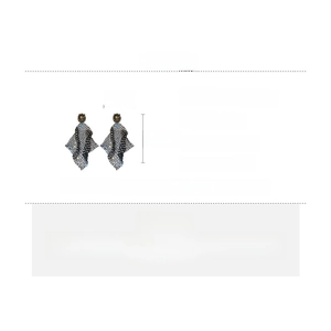 Detail view of large alloy mesh earrings with rhinestones and vintage lion head stud