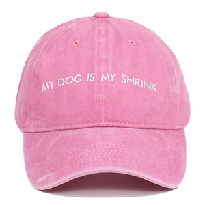 Close-up of MY DOG IS MY SHRINK embroidery on a pink washed cotton baseball cap