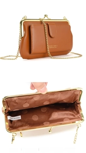 Brown leather crossbody bag detail showing open compartments for phone and cards