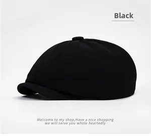 Detailed view of black twill octagonal newsboy cap showing fabric texture and top button