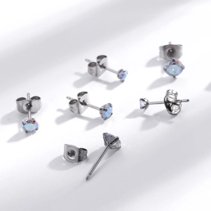 Minimalist stainless steel stud earrings with round colorful zircon on white background