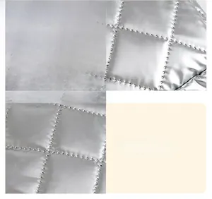 Detail of silver quilted PU leather fabric with precise diamond stitching and metallic finish