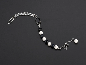 Macro view of adjustable hip-hop bracelet with black gemstone and white beads