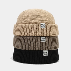 Retro knit dockers cap in beige, brown and black featuring a stylish minimalist label