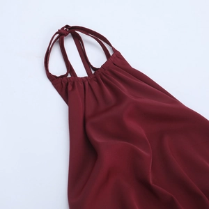 Detail of burgundy satin dress showing the halter neck drawstring and sleek fabric