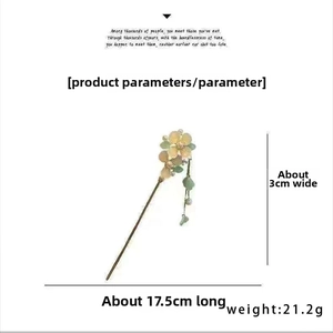 Detailed view of vintage hair pin with yellow petals, green beads and 17.5cm scale