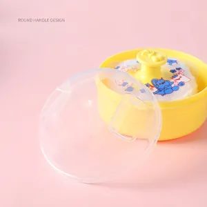Baby powder puff set with handle and yellow storage case on soft pink background