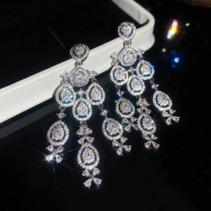 Macro view of silver water drop tassel earrings with sparkling zircon floral details