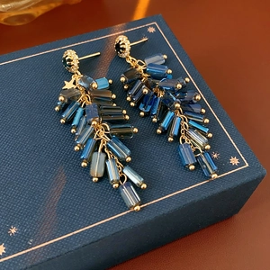 Detail of New Chinese style tassel earrings with blue crystals and golden hardware