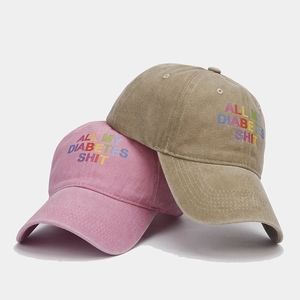 Vintage washed cotton baseball caps in pink and khaki with letter graphic design