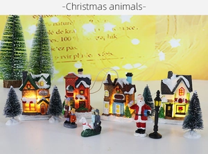 Detailed Christmas village set with glowing miniature houses and tiny pine trees