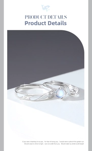 Close-up of luminous whale-themed 925 silver couple rings with iridescent moonstone