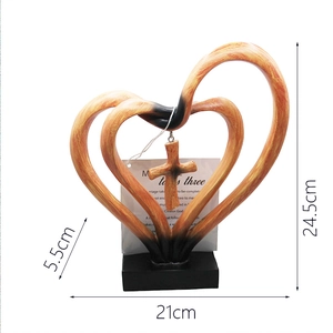 Macro shot of interlocking heart cross resin sculpture with detailed dimensions and card