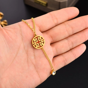 Detail of 18K gold plated necklace with red Fu character pendant and crystal charm