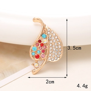 Detailed macro view of leaf shaped brooch with colorful rhinestones and size dimensions