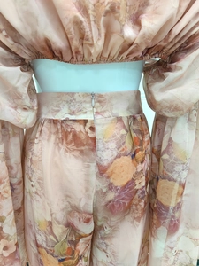 Detail of off-shoulder floral chiffon top with elastic hem and wide-leg pant set
