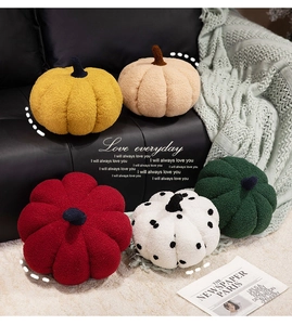 Variety of plush pumpkin cushions in five colors on a sofa with cozy home decor