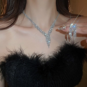 Luxury tassel jewelry set with zircon necklace and earrings on a model in dark setting