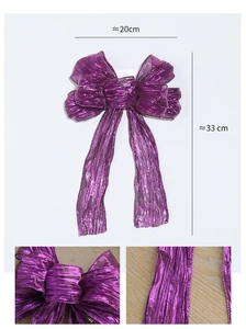 Macro detail of purple glitter fabric texture on a 20x33cm Christmas decorative bow