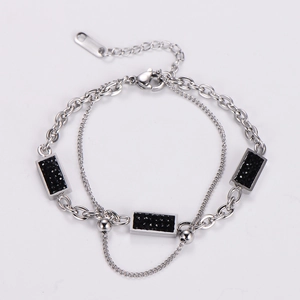 Macro detail of double-layer chain bracelet with rectangular black stones and lobster clasp