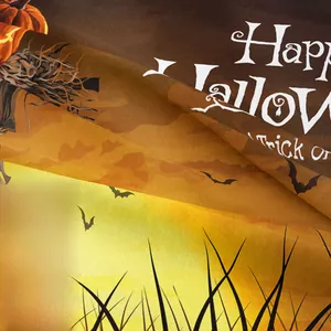 Close-up of Halloween tapestry fabric showing pumpkin prints and woven texture detail